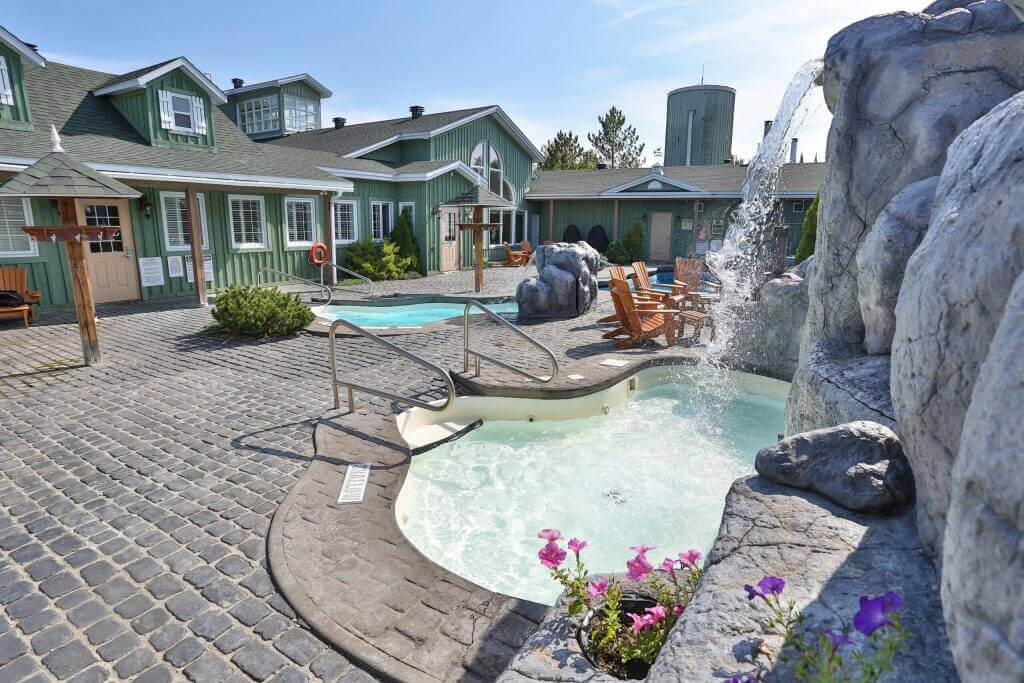 Sleeping With The Wolves A hot tub with a waterfall in front of it at Cedar Meadows, Timmins Ontario. Cedar Meadows, Timmins, Ontario