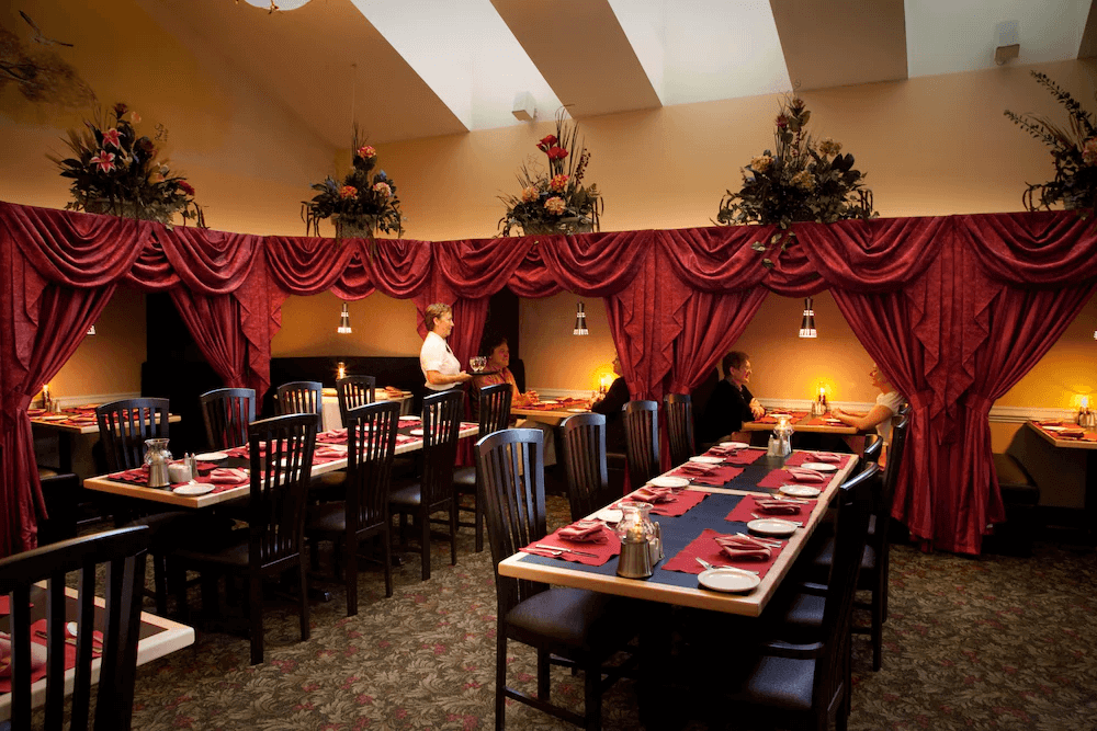 Sleeping With The Wolves A dining room in Cedar Meadows with red curtains. Cedar Meadows, Timmins, Ontario